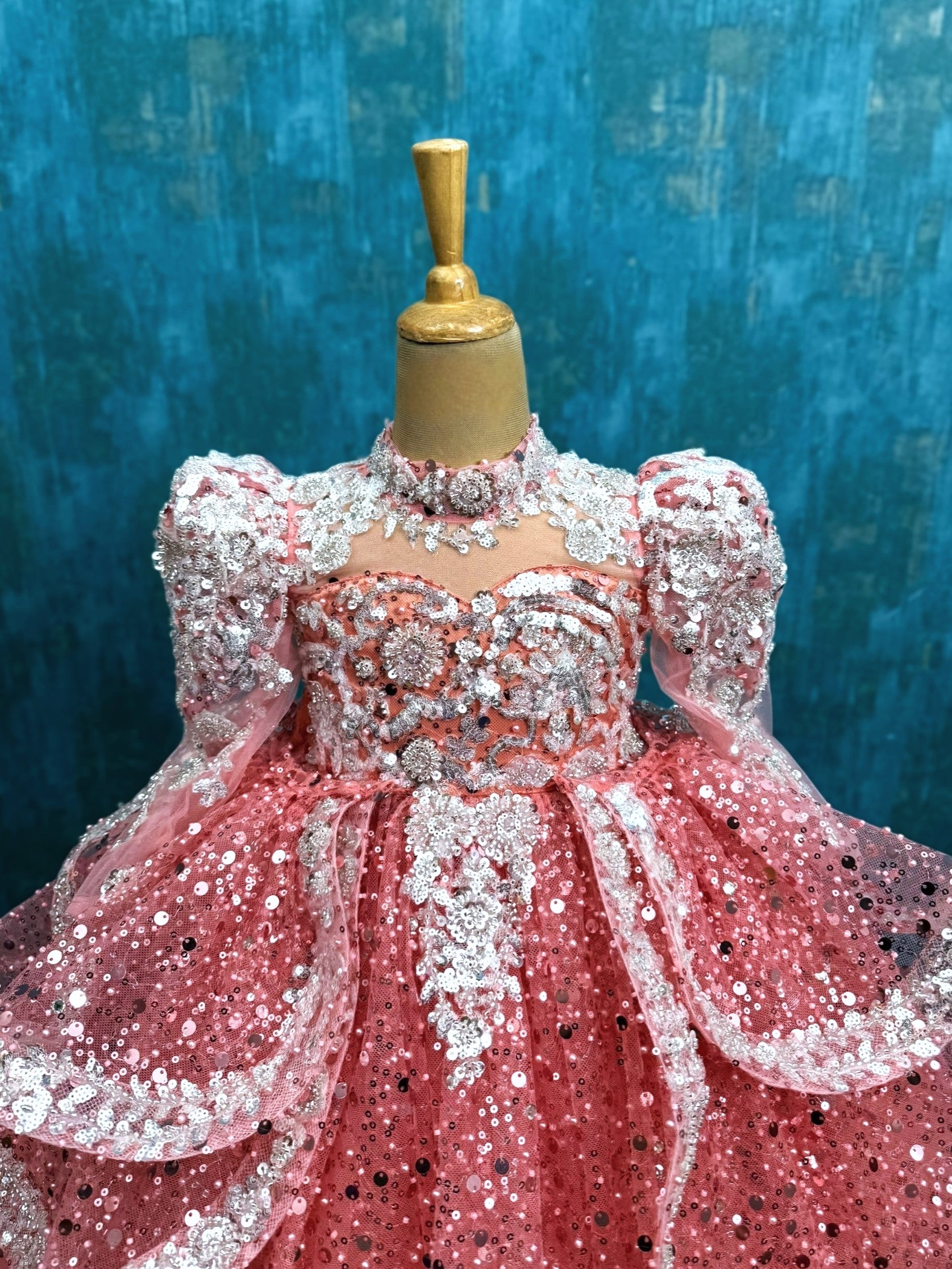 peach sequence ball gown with high neck and puff sleeves with silver intricate work