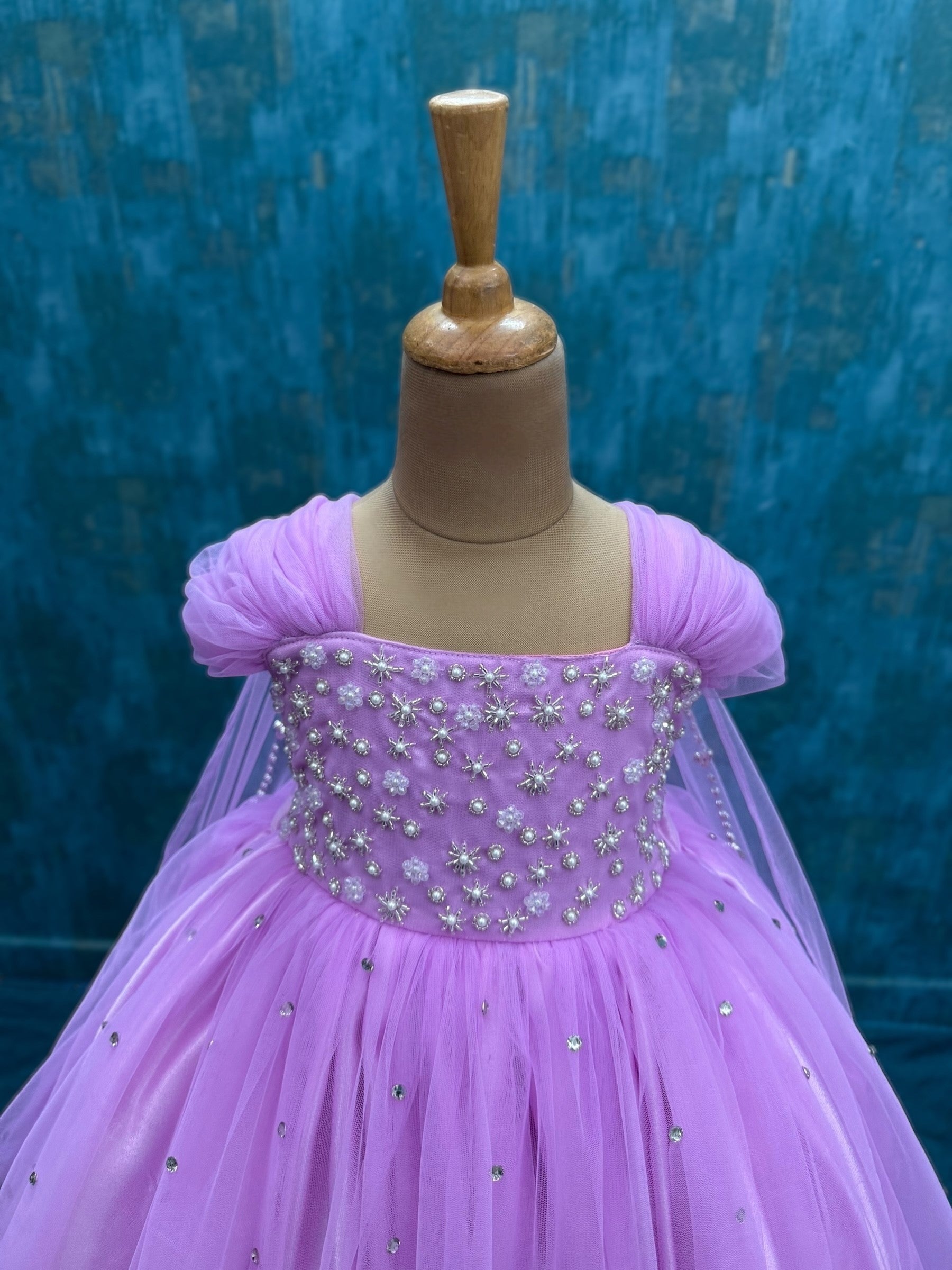 lavender gown with intricate hand work and attached veil