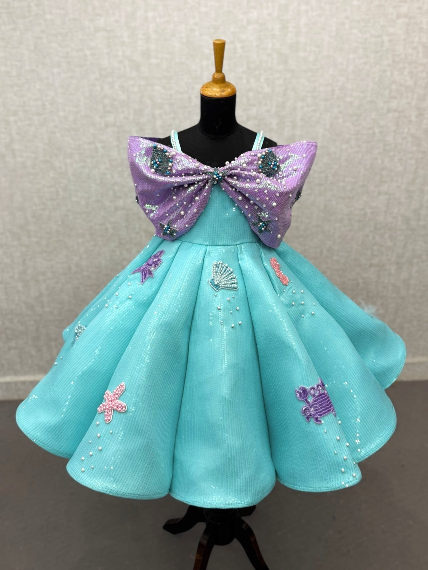 turquoise and lavender sequence panel gown with overlapping bow and intricate hand work