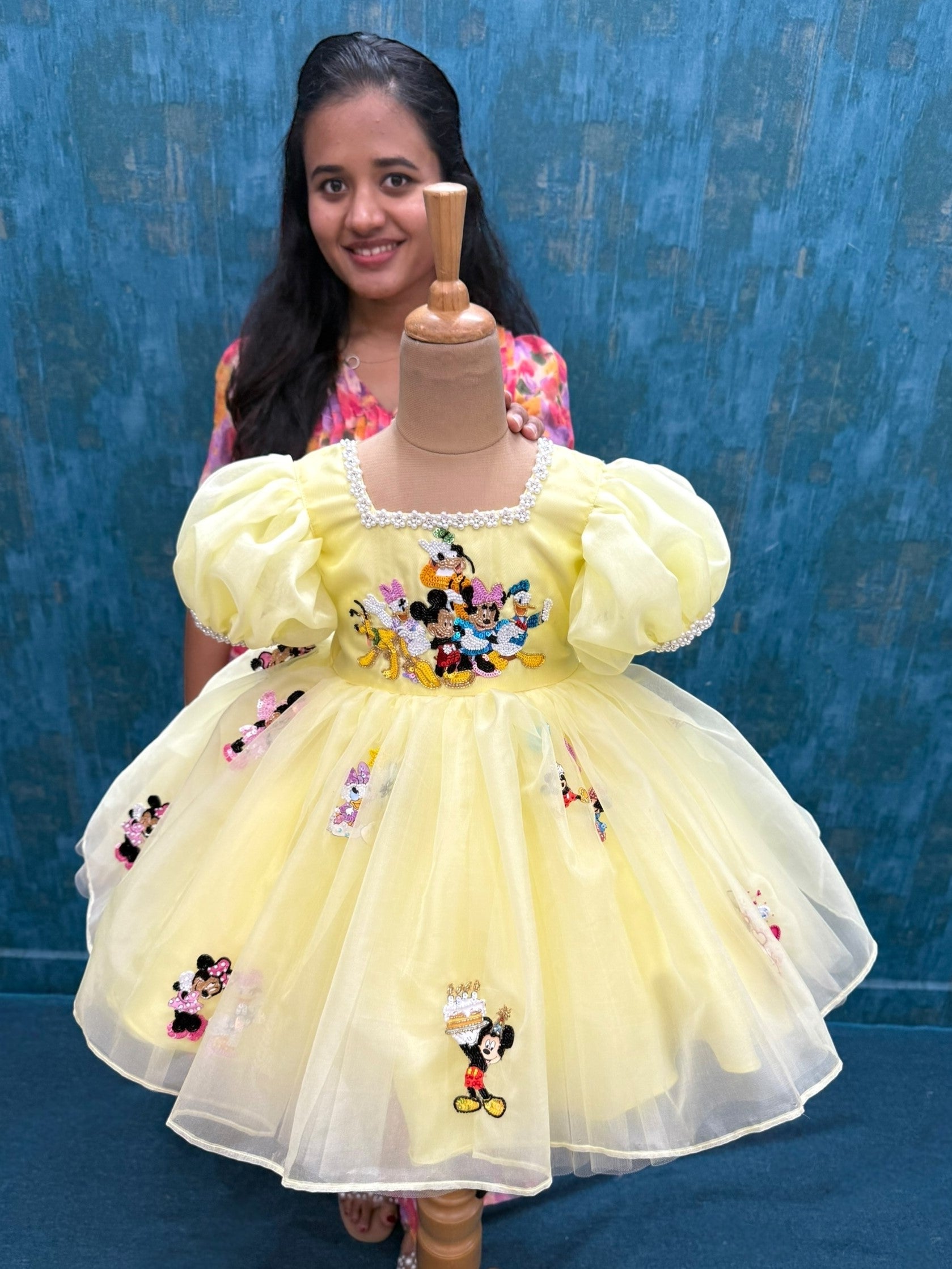 pale yellow mickey theme organza dress with intricate hand work