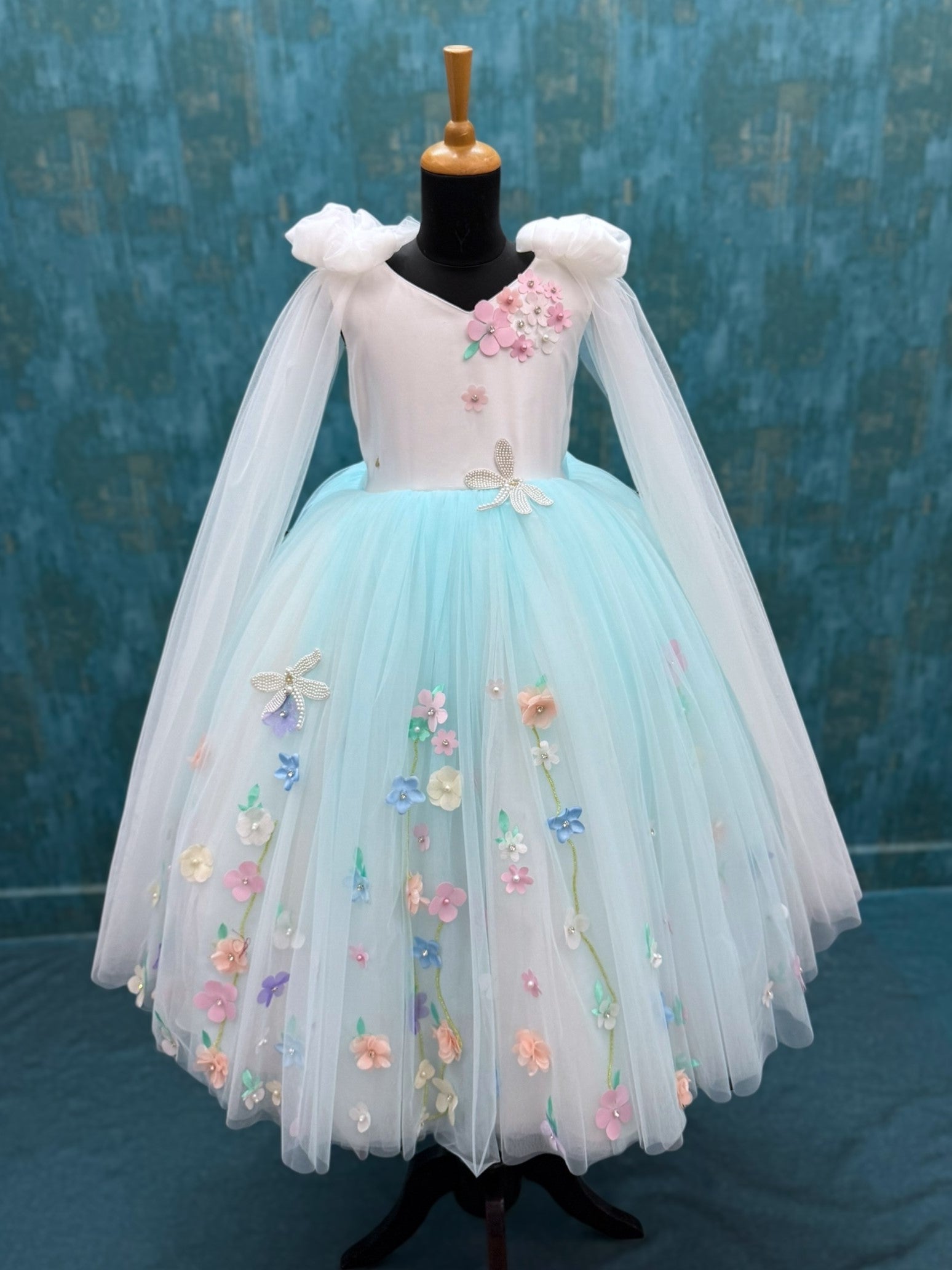 white and blue floral ball gown with bow shoulders