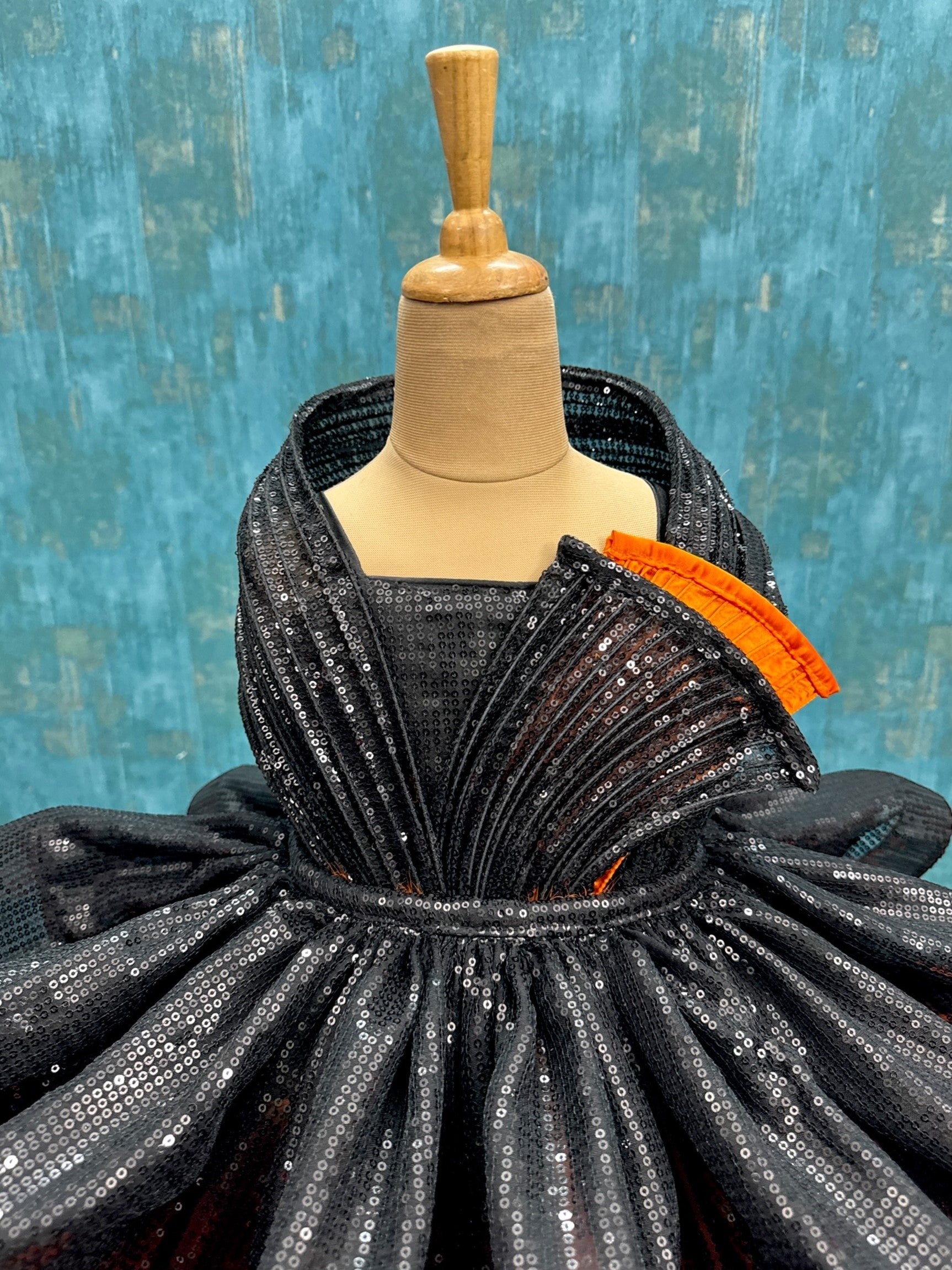 Orange feather structure ball with detachable black sequin skirt