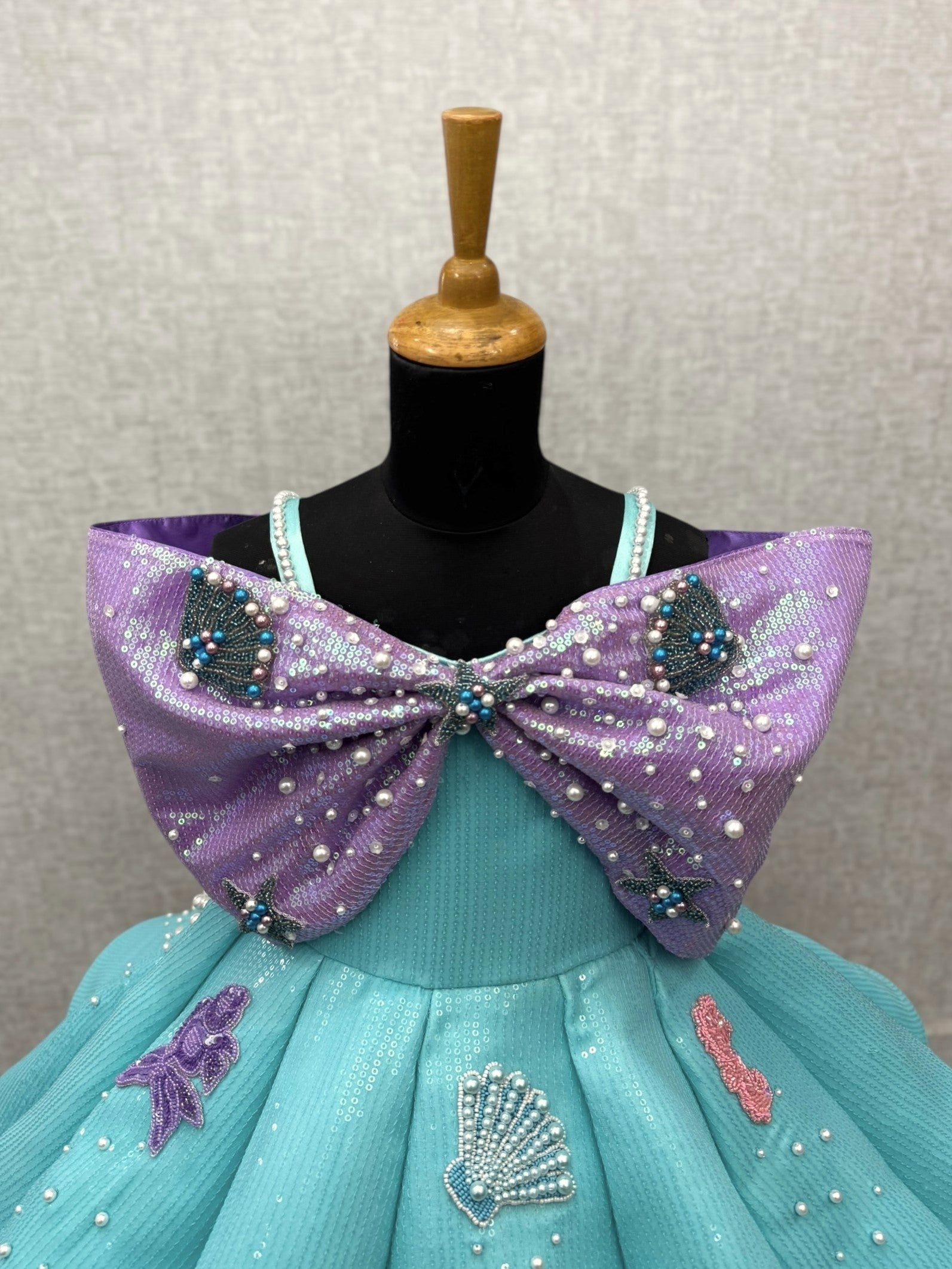 turquoise and lavender sequence panel gown with overlapping bow and intricate hand work