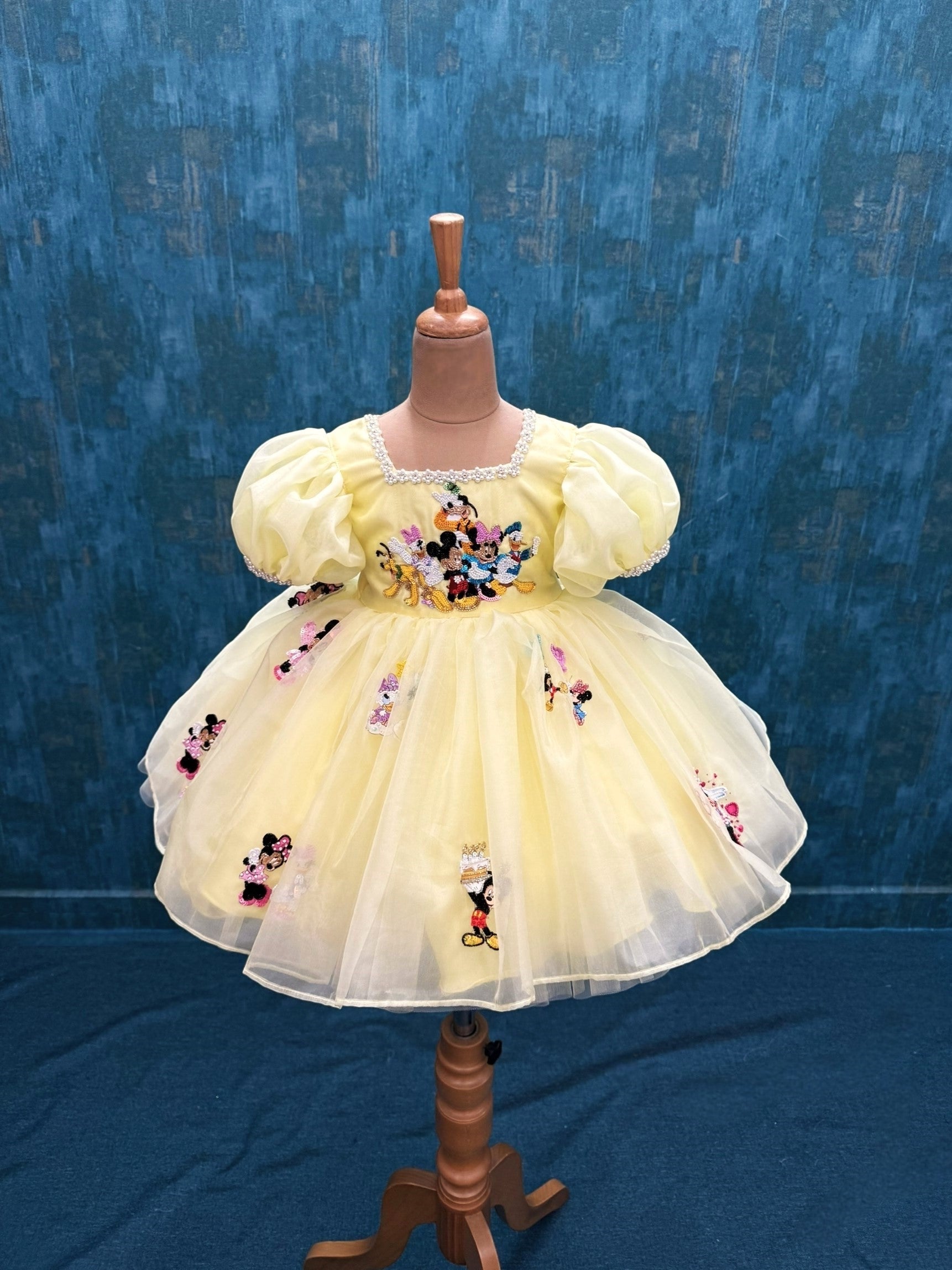 pale yellow mickey theme organza dress with intricate hand work