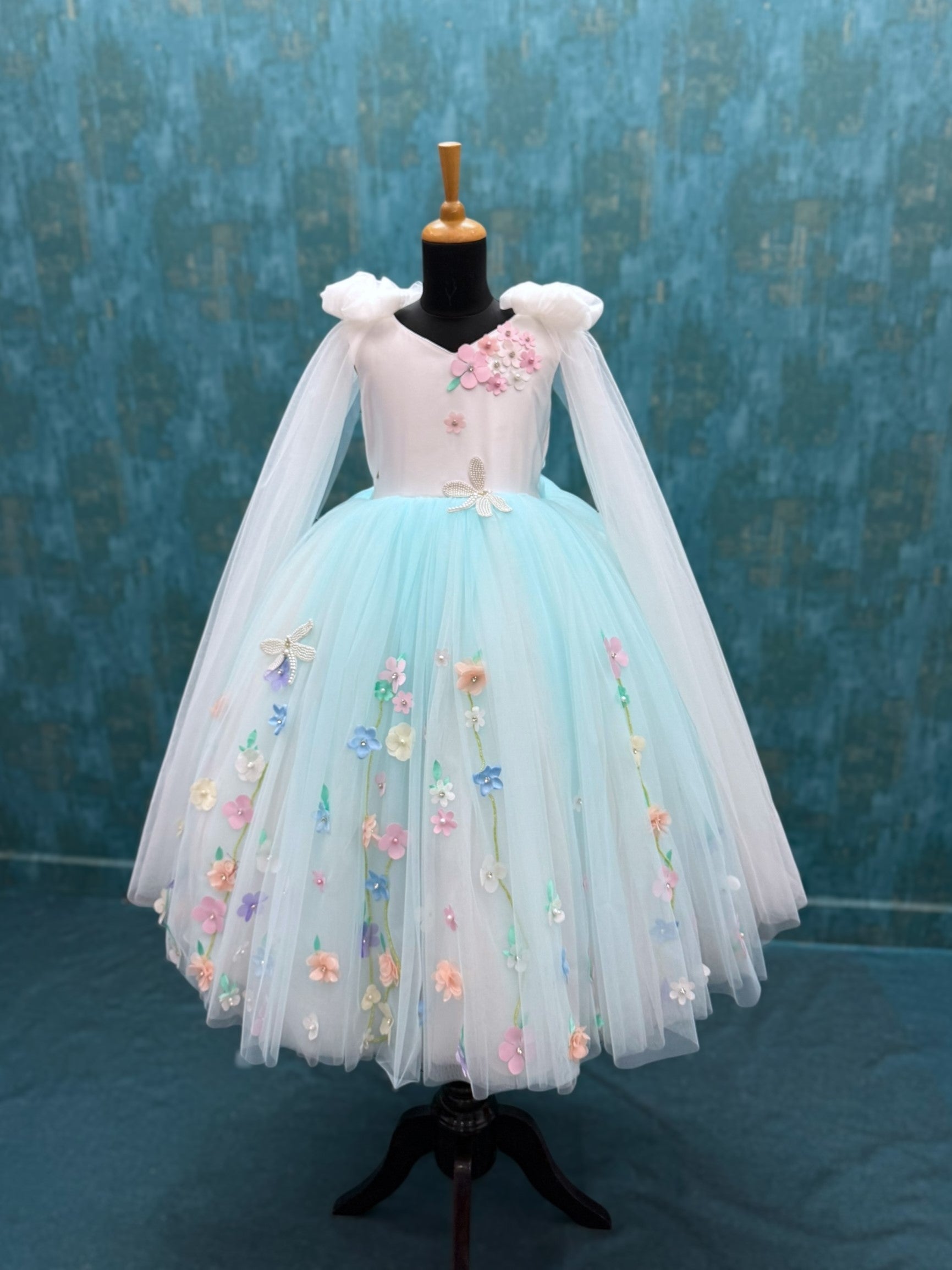 white and blue floral ball gown with bow shoulders