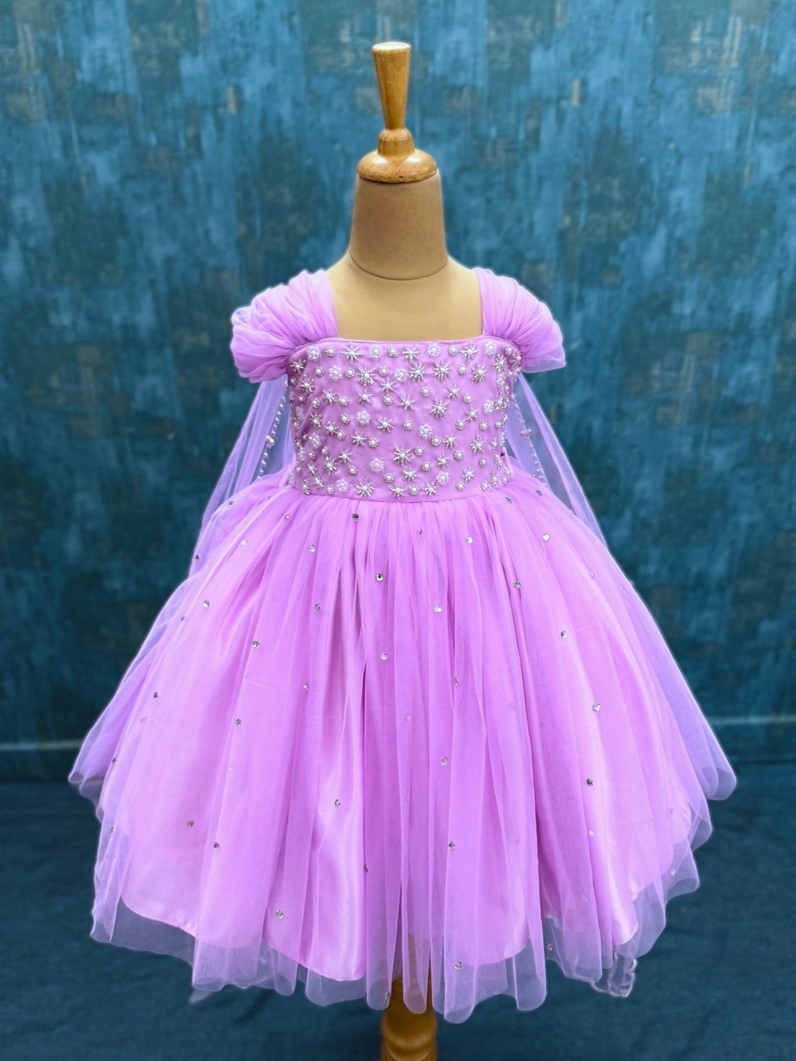 lavender gown with intricate hand work and attached veil