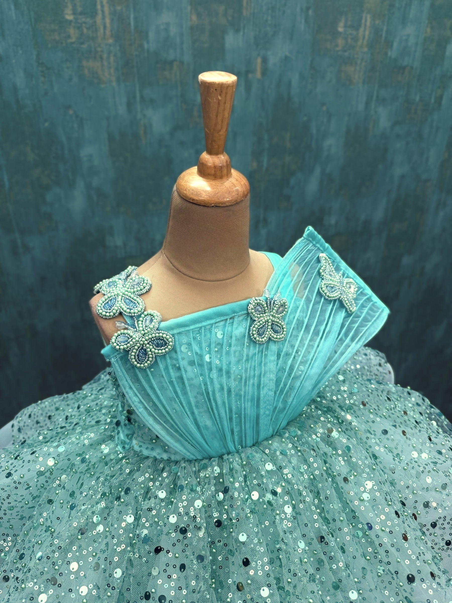 turquoise sequence layer gown with butterfly detailing