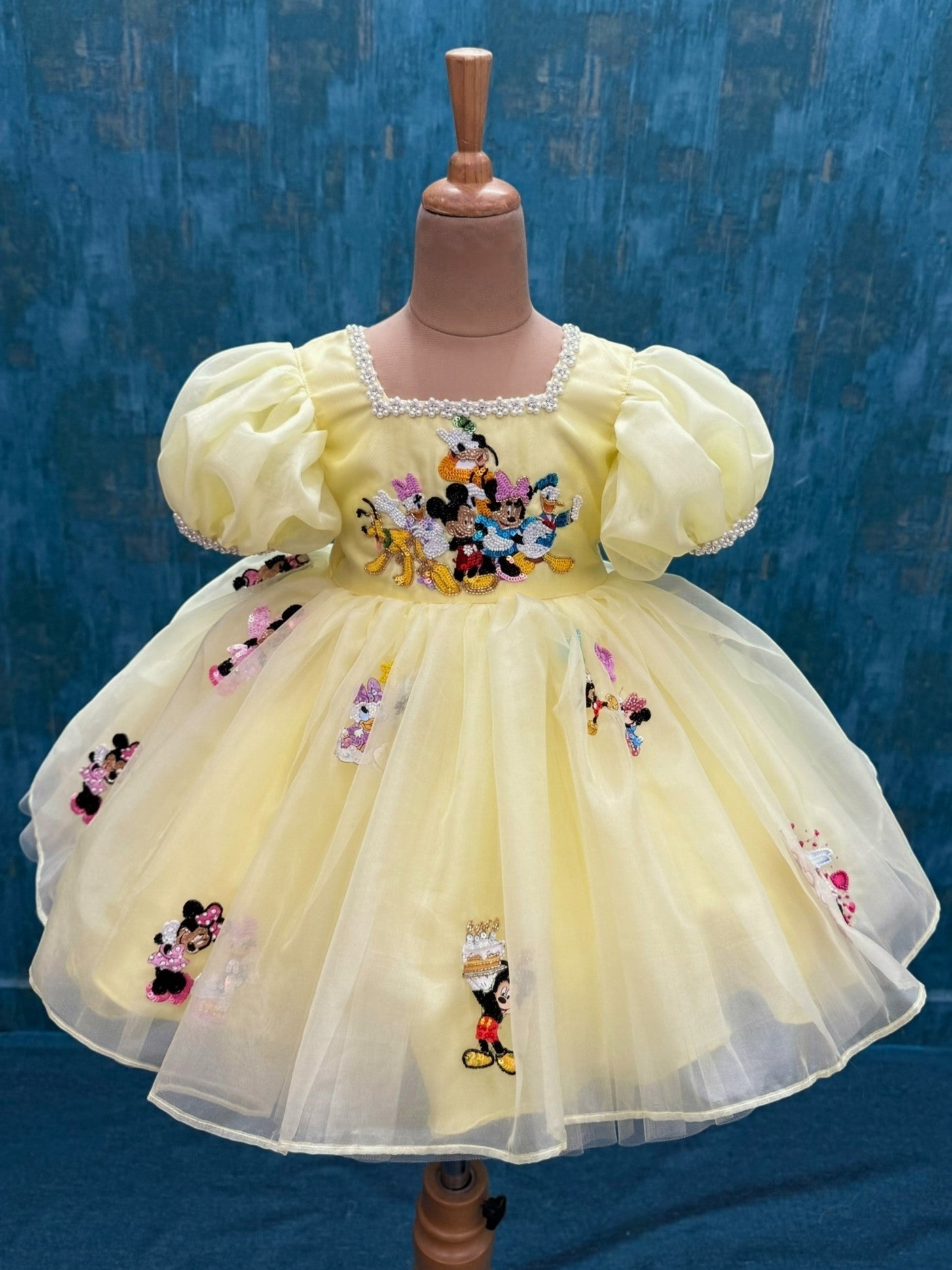 pale yellow mickey theme organza dress with intricate hand work