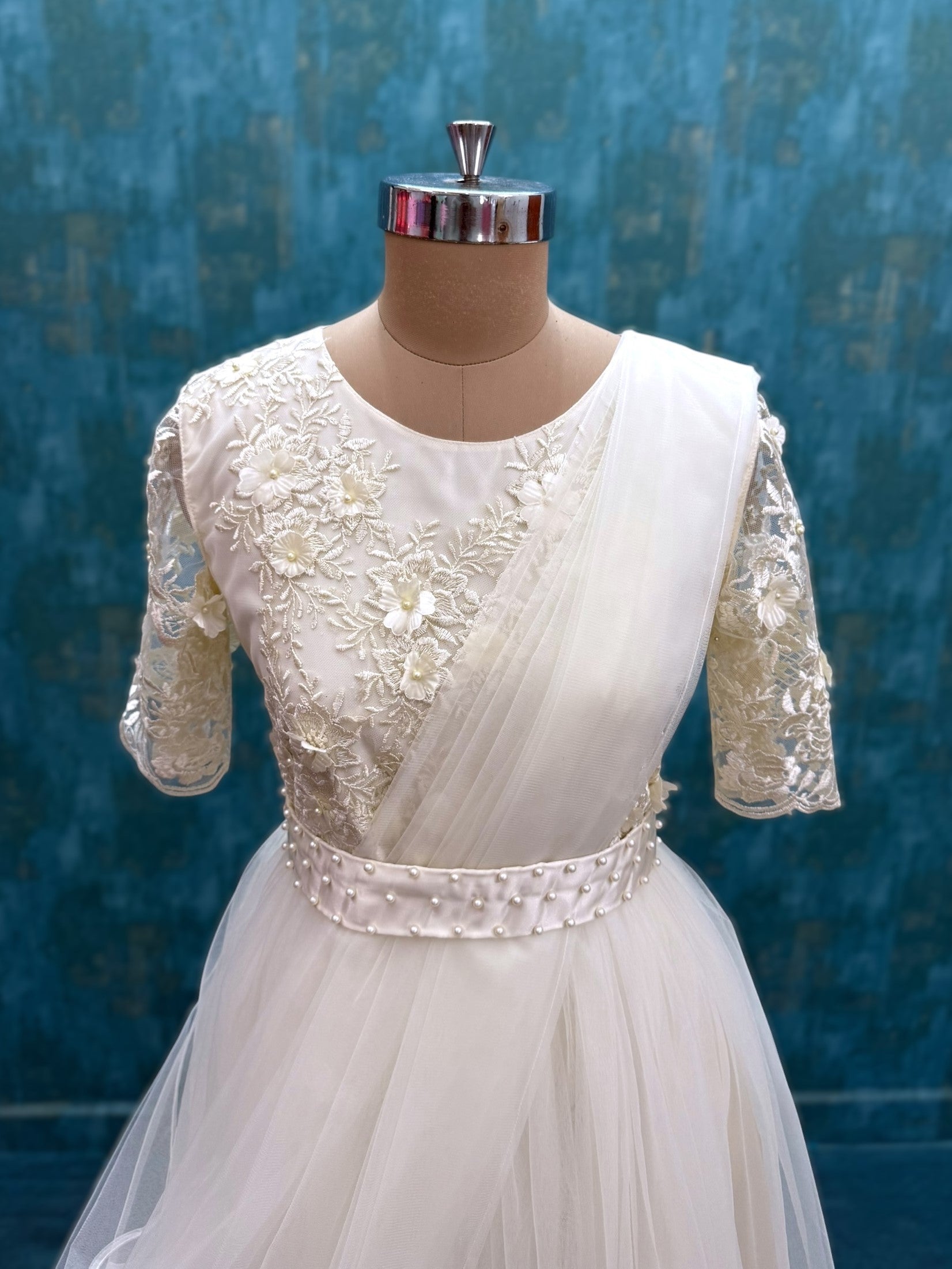 Half white floral net gown with attached dupatta and waist belt