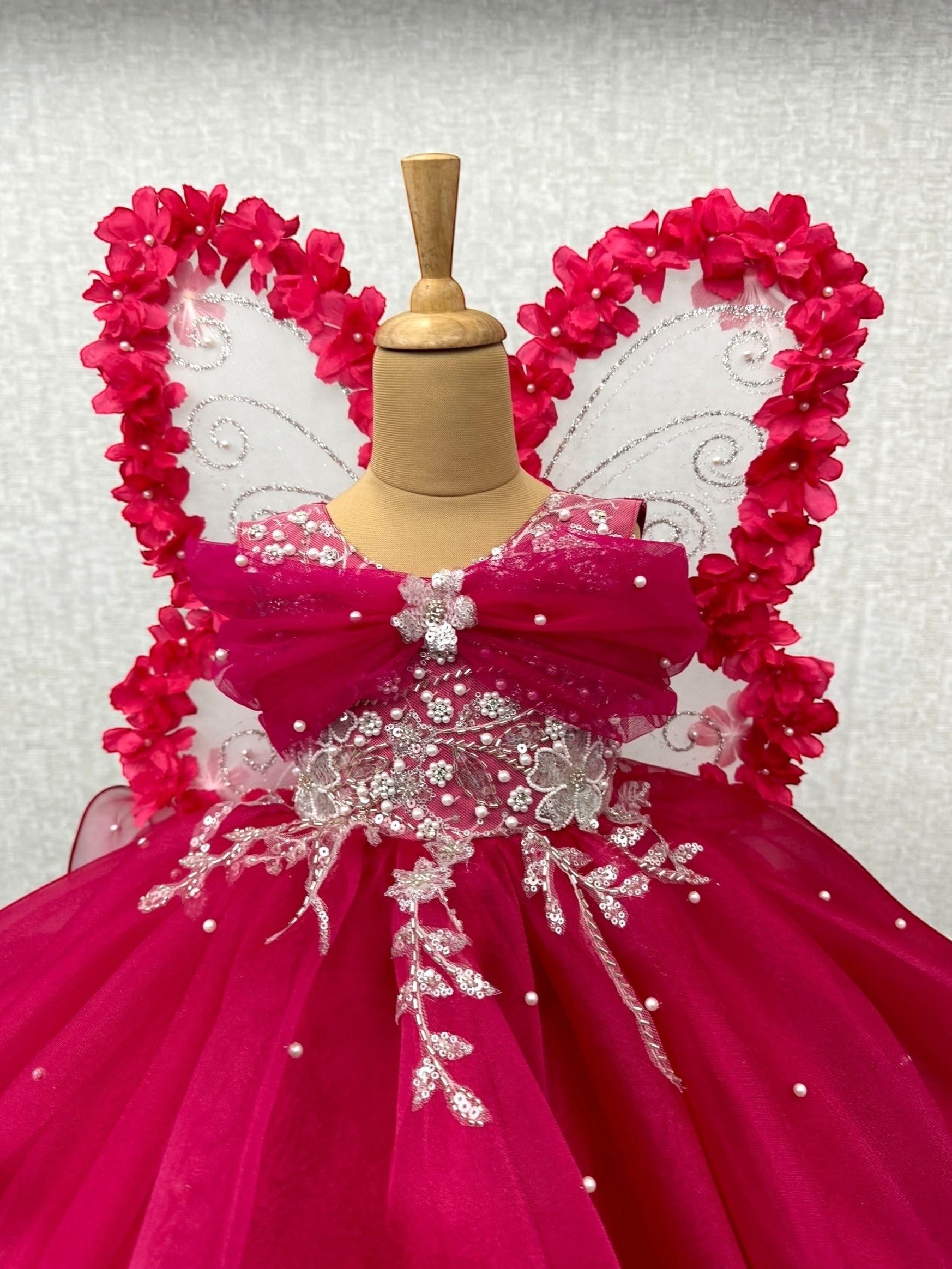 pink organza layered gown with silver work and floral butterfly wings