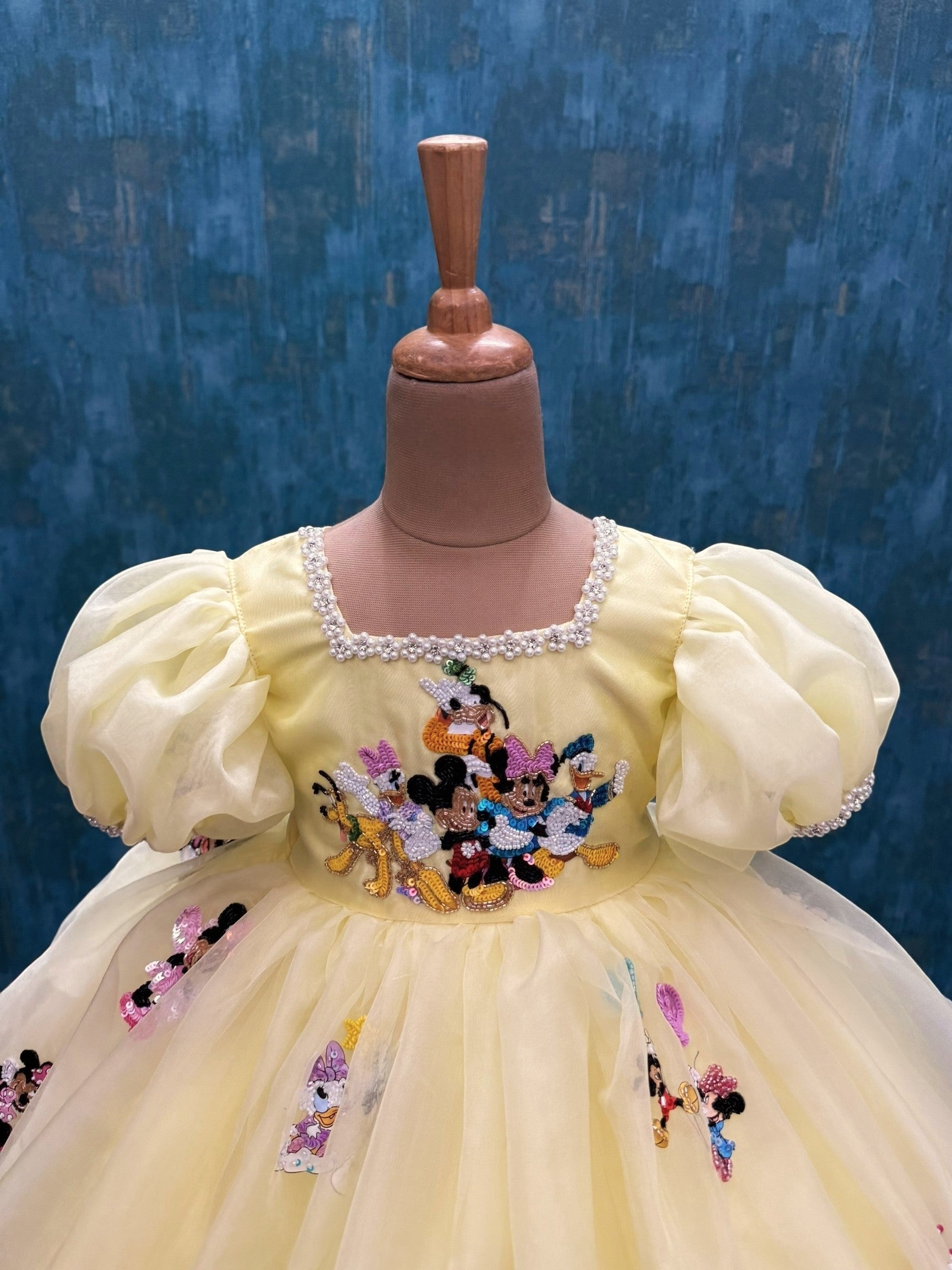 pale yellow mickey theme organza dress with intricate hand work