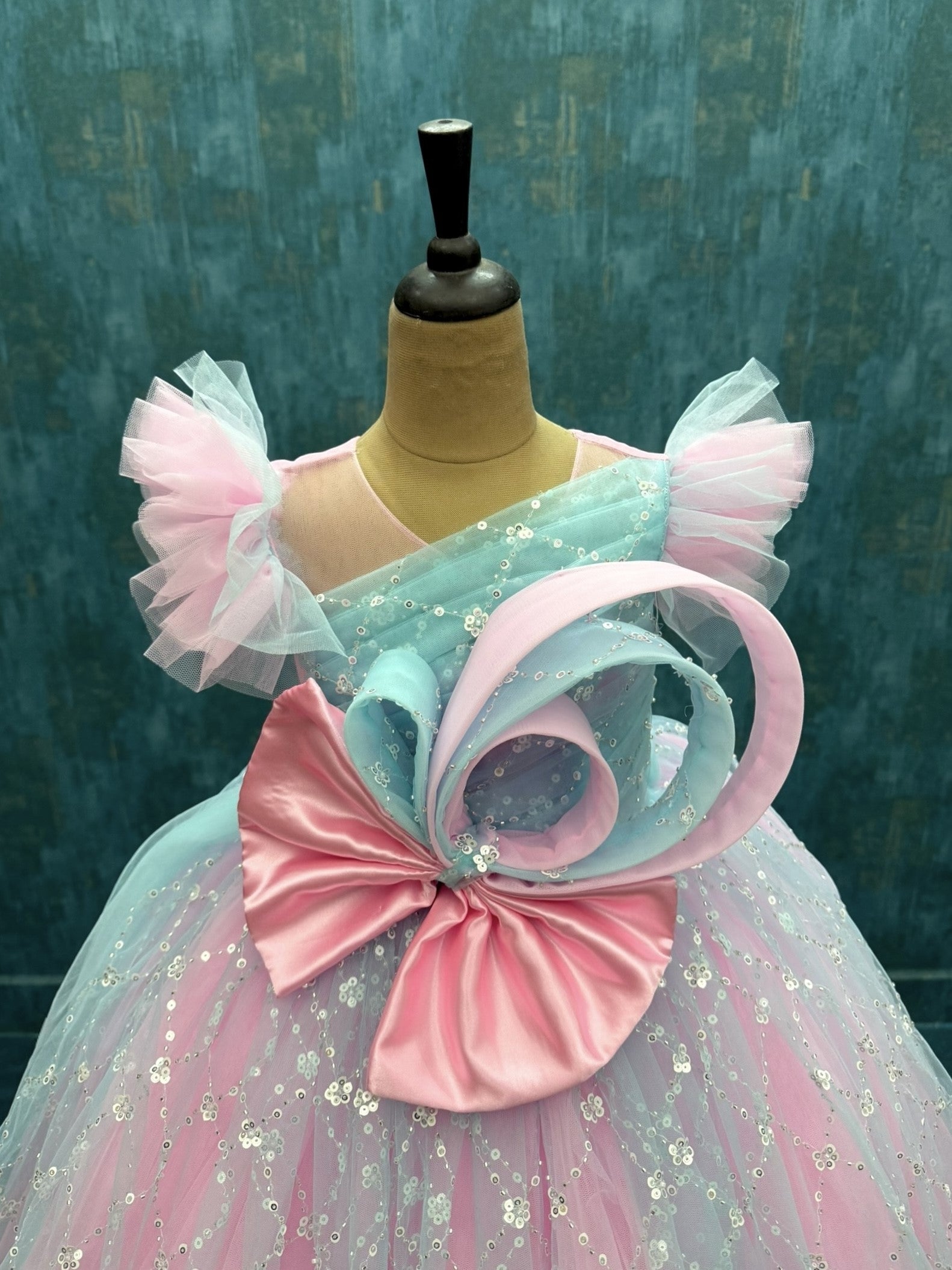 Blue and pink sequence ball gown with bow detailing