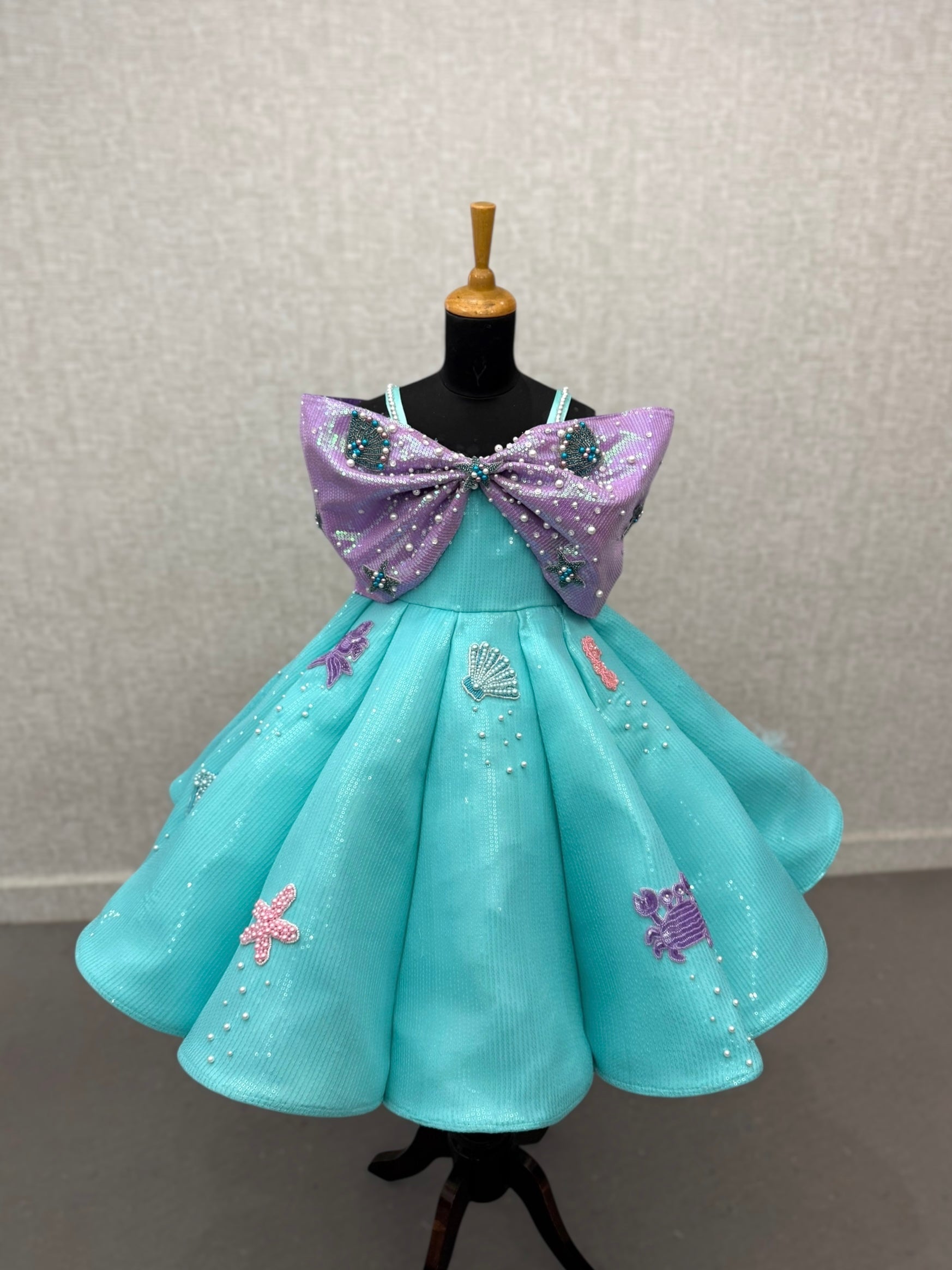 turquoise and lavender sequence panel gown with overlapping bow and intricate hand work