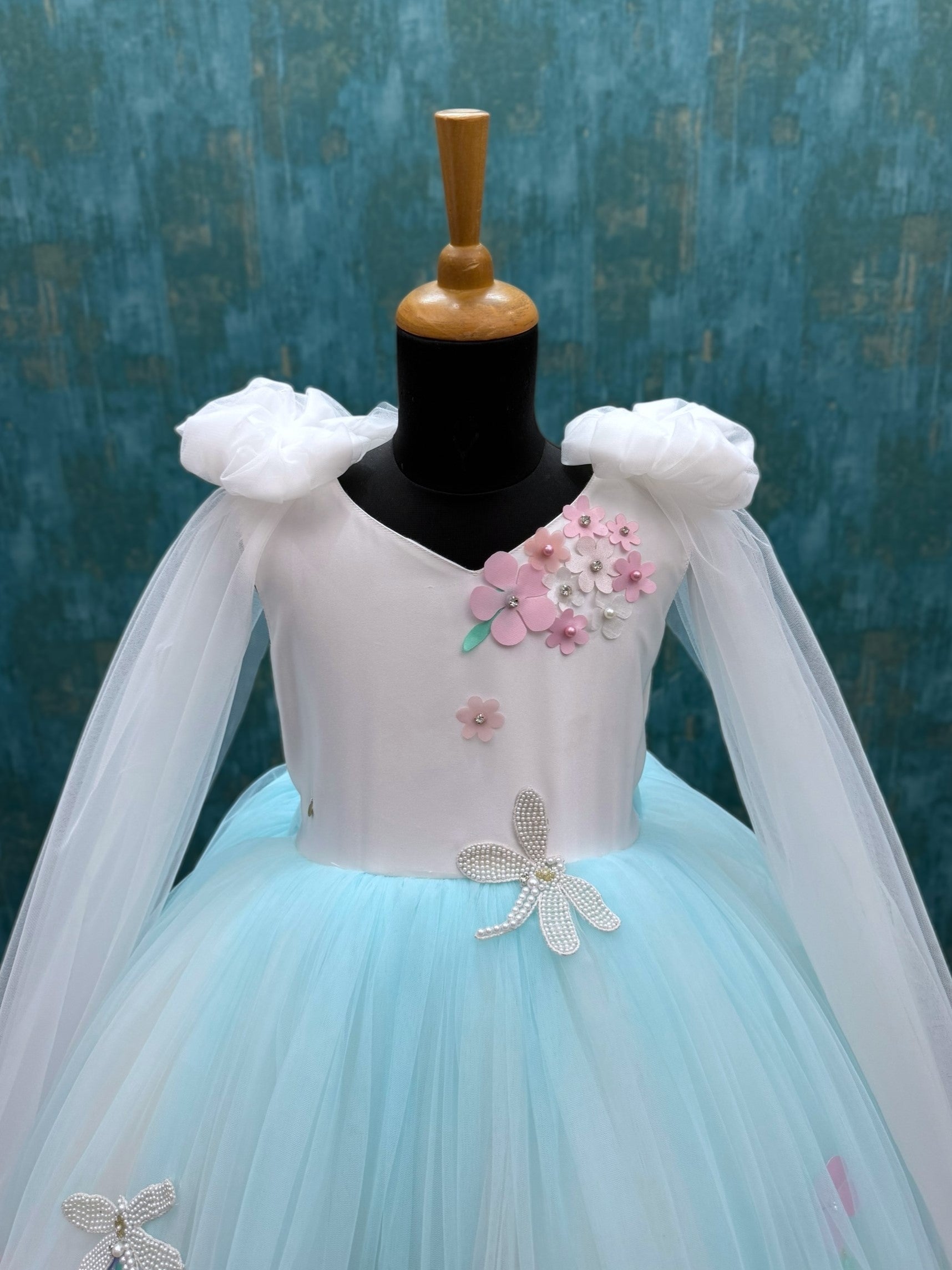 white and blue floral ball gown with bow shoulders