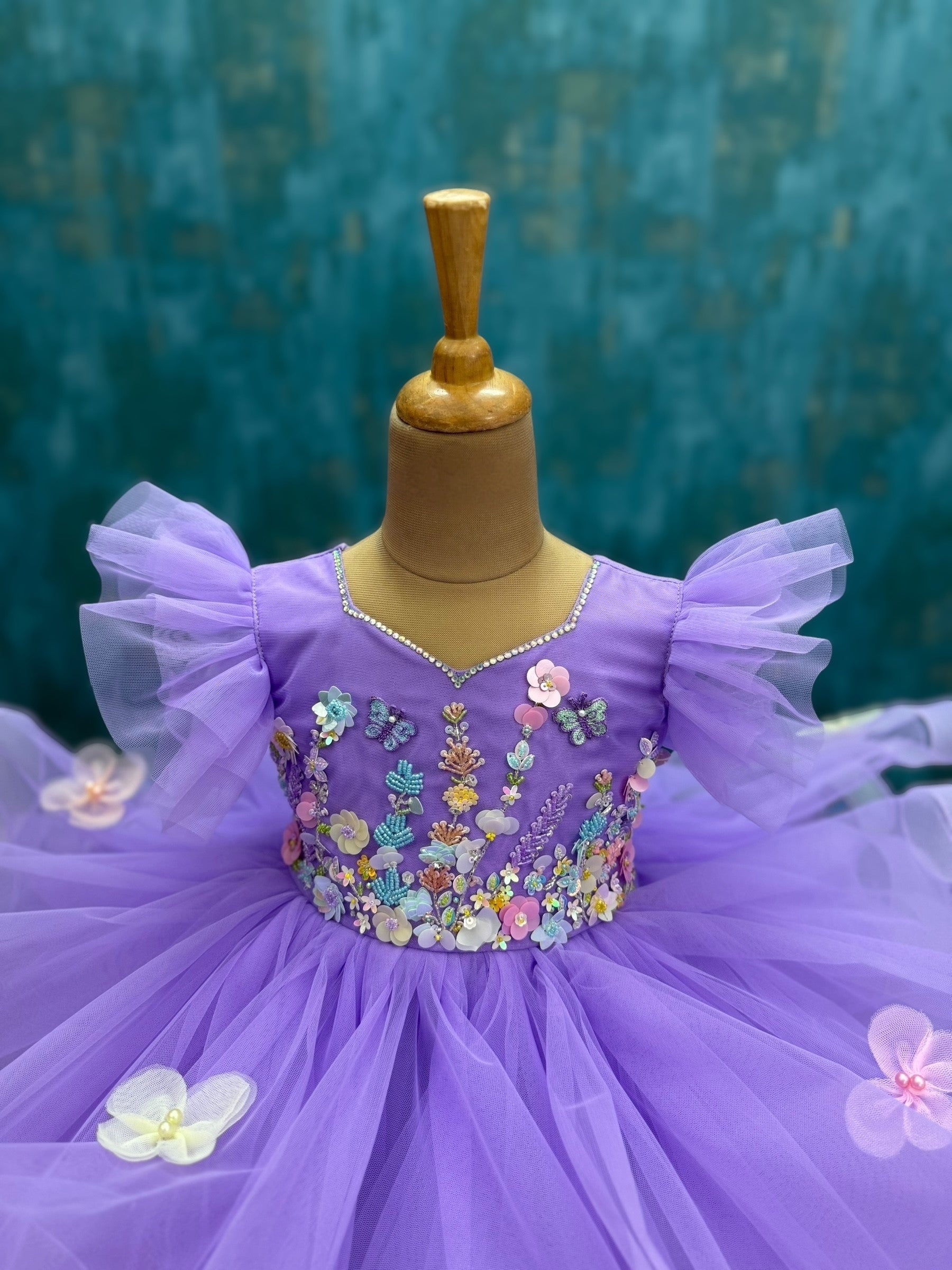 lavender ruffle gown with intricate floral work with 3d butterflies