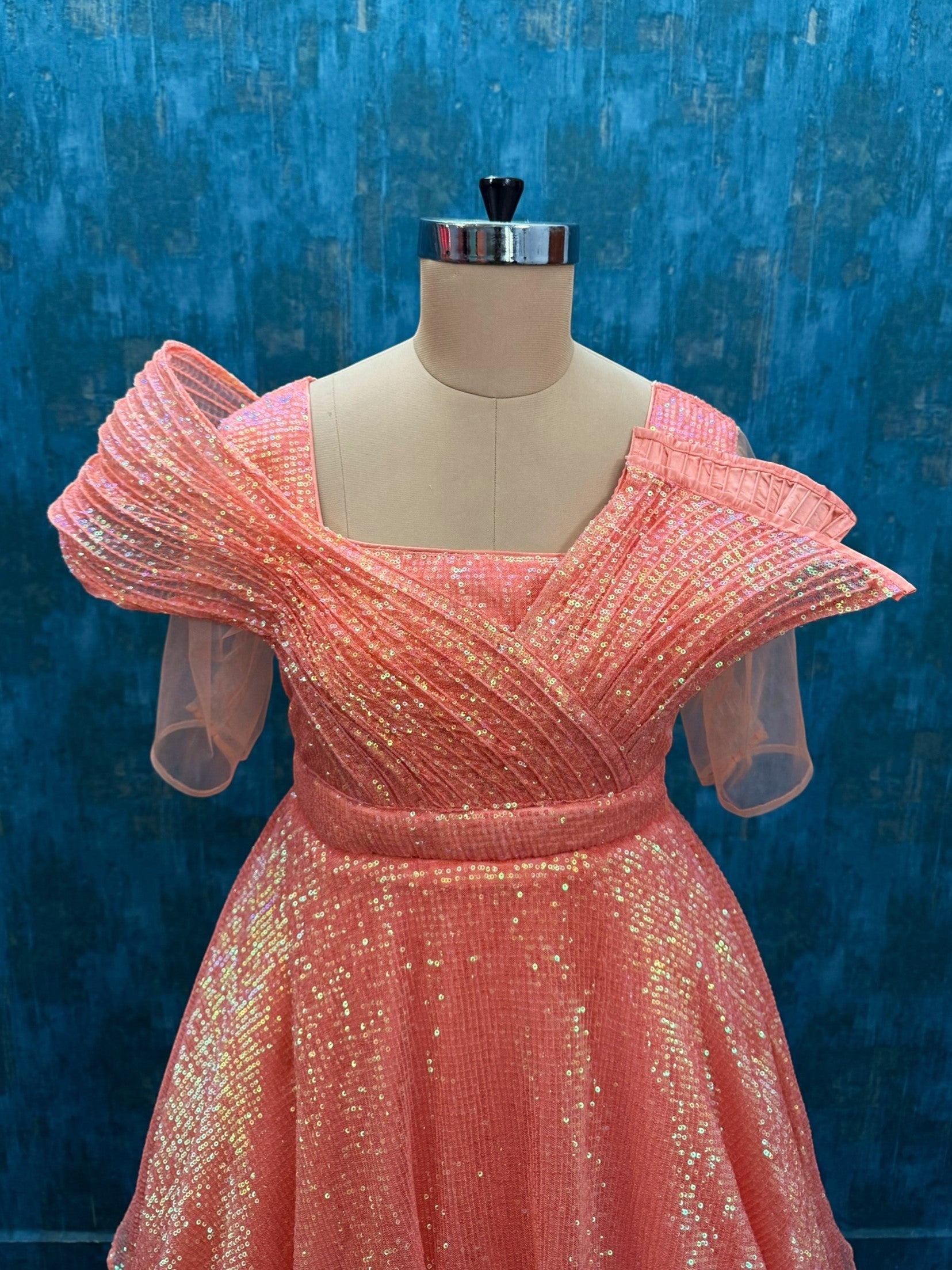 Structured sequence peach gown with uneven cut skirt