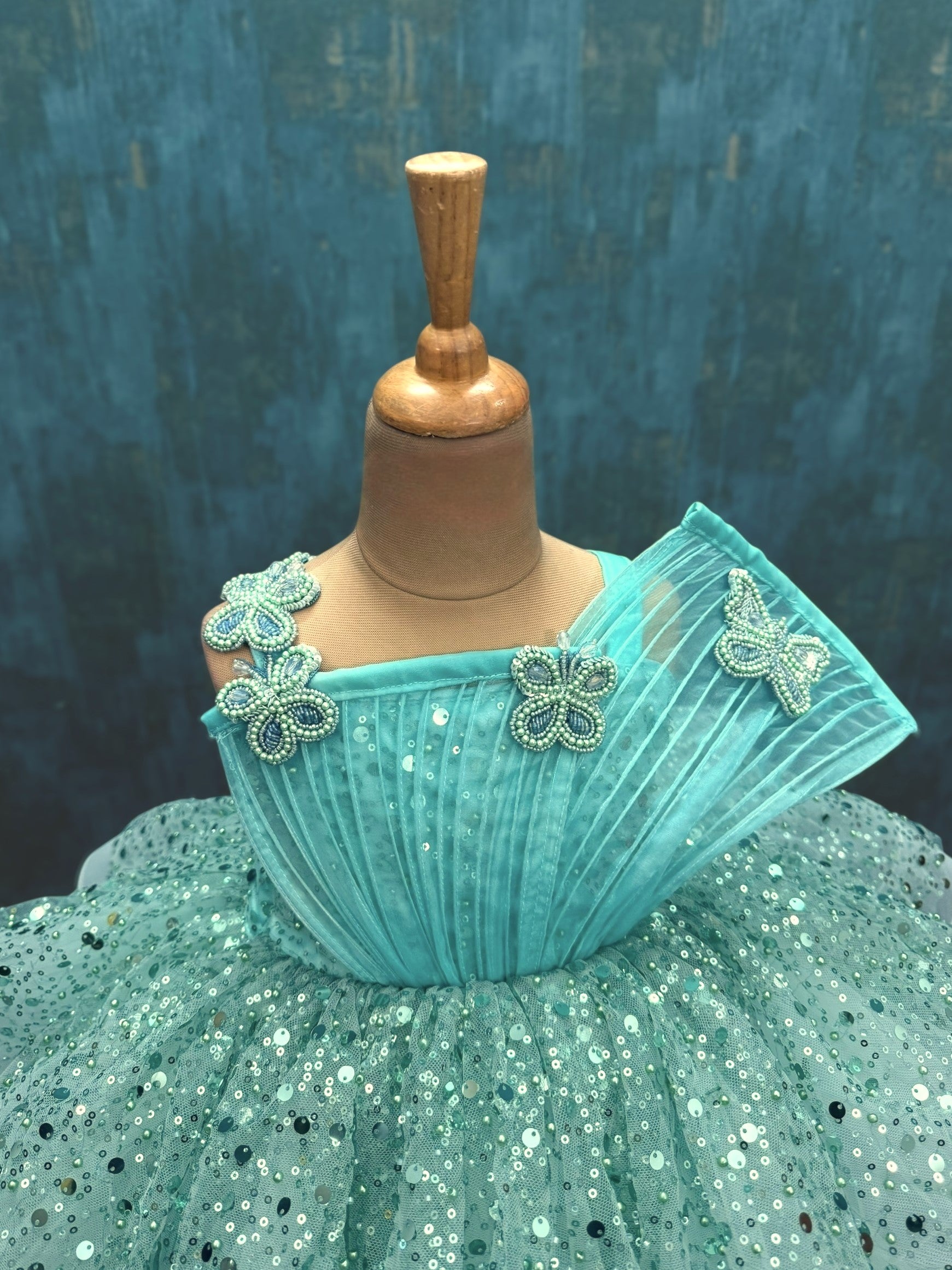 turquoise sequence layer gown with butterfly detailing