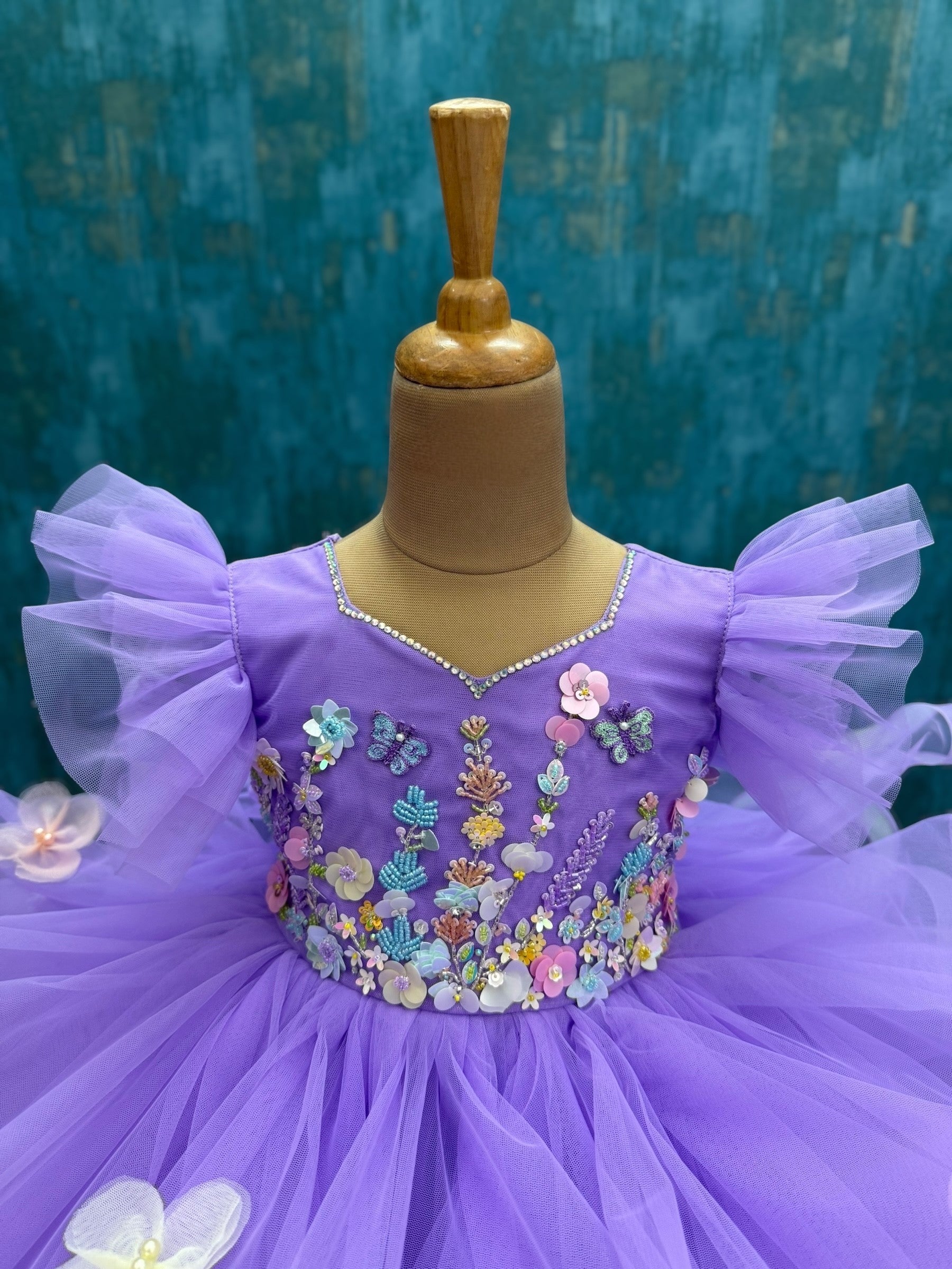 lavender ruffle gown with intricate floral work with 3d butterflies
