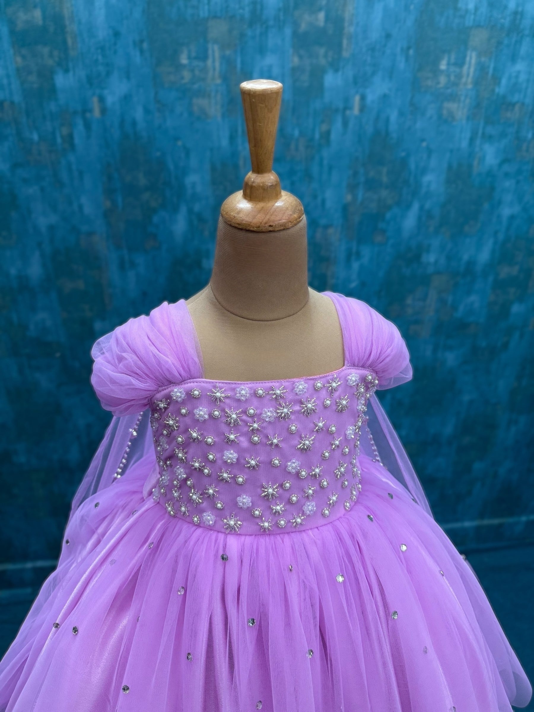 lavender gown with intricate hand work and attached veil