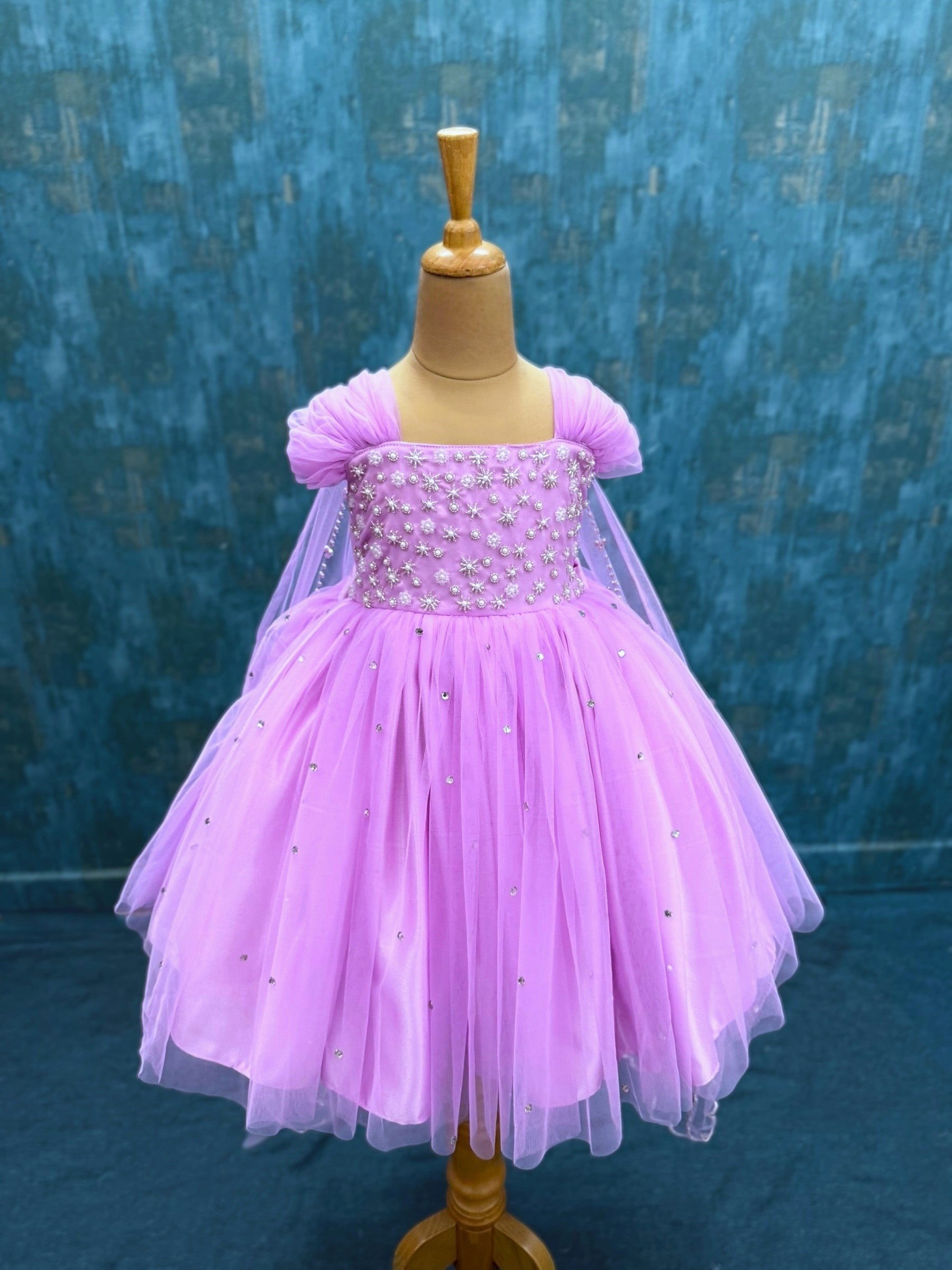 lavender gown with intricate hand work and attached veil