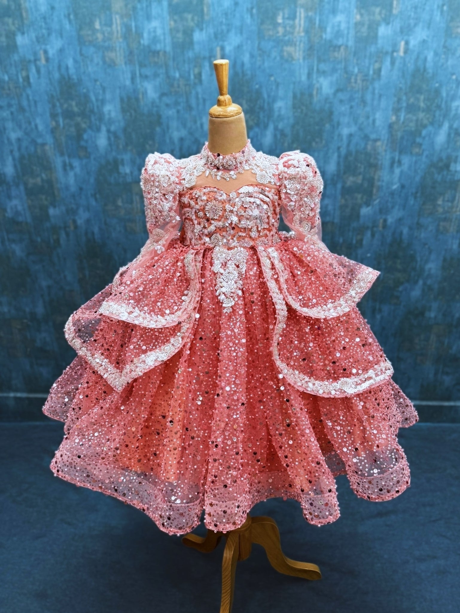 peach sequence ball gown with high neck and puff sleeves with silver intricate work
