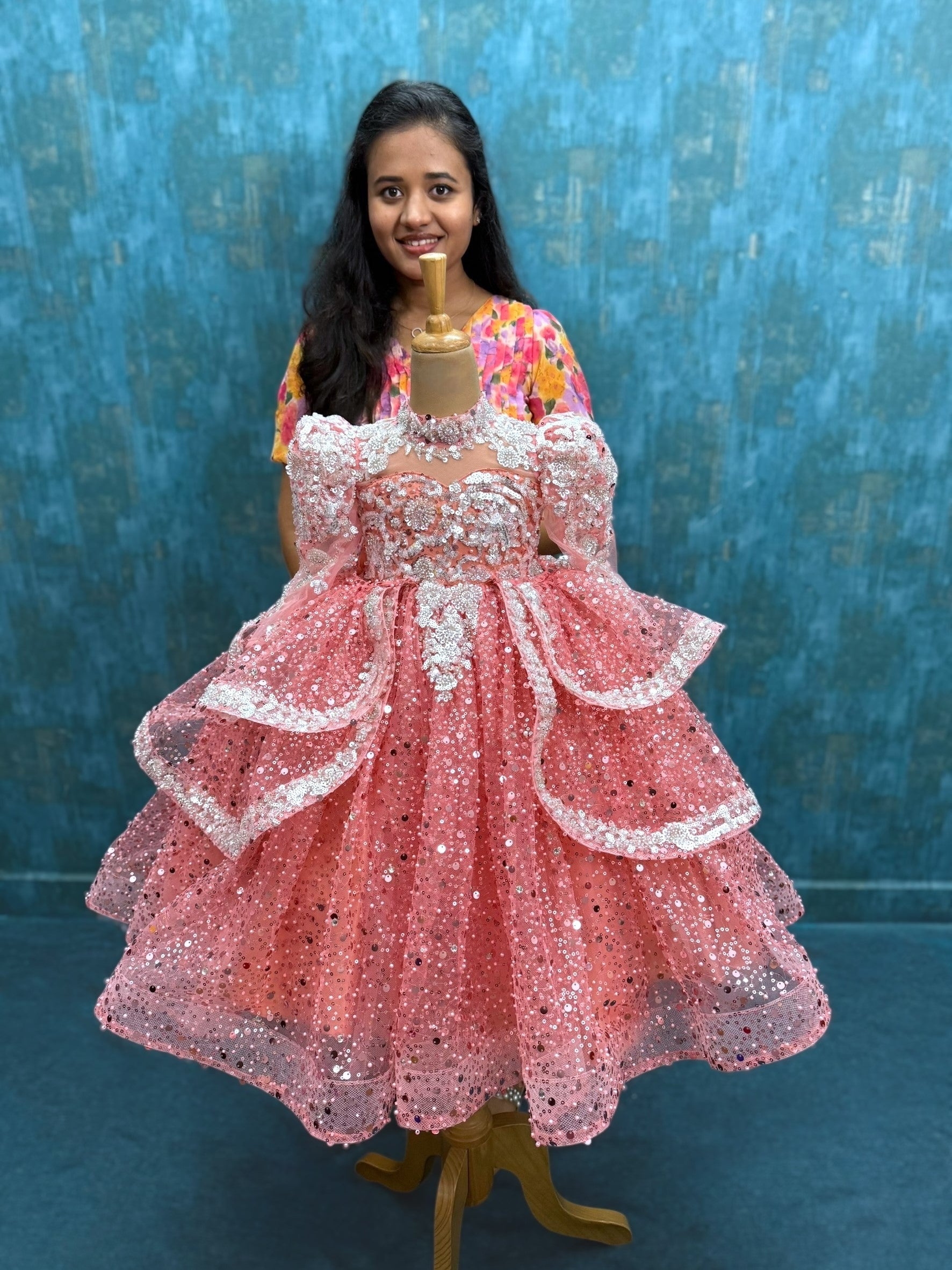 peach sequence ball gown with high neck and puff sleeves with silver intricate work