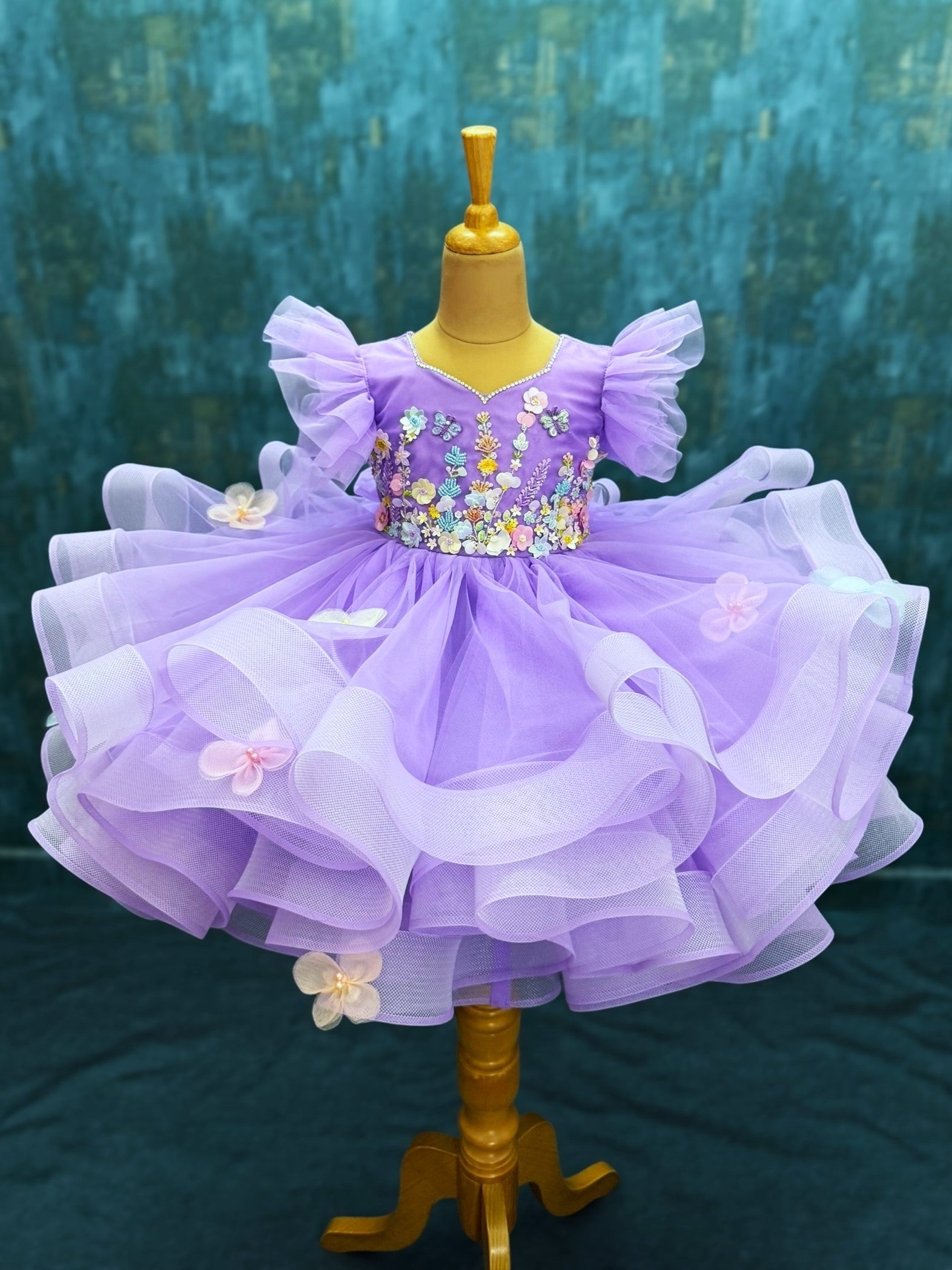 lavender ruffle gown with intricate floral work with 3d butterflies