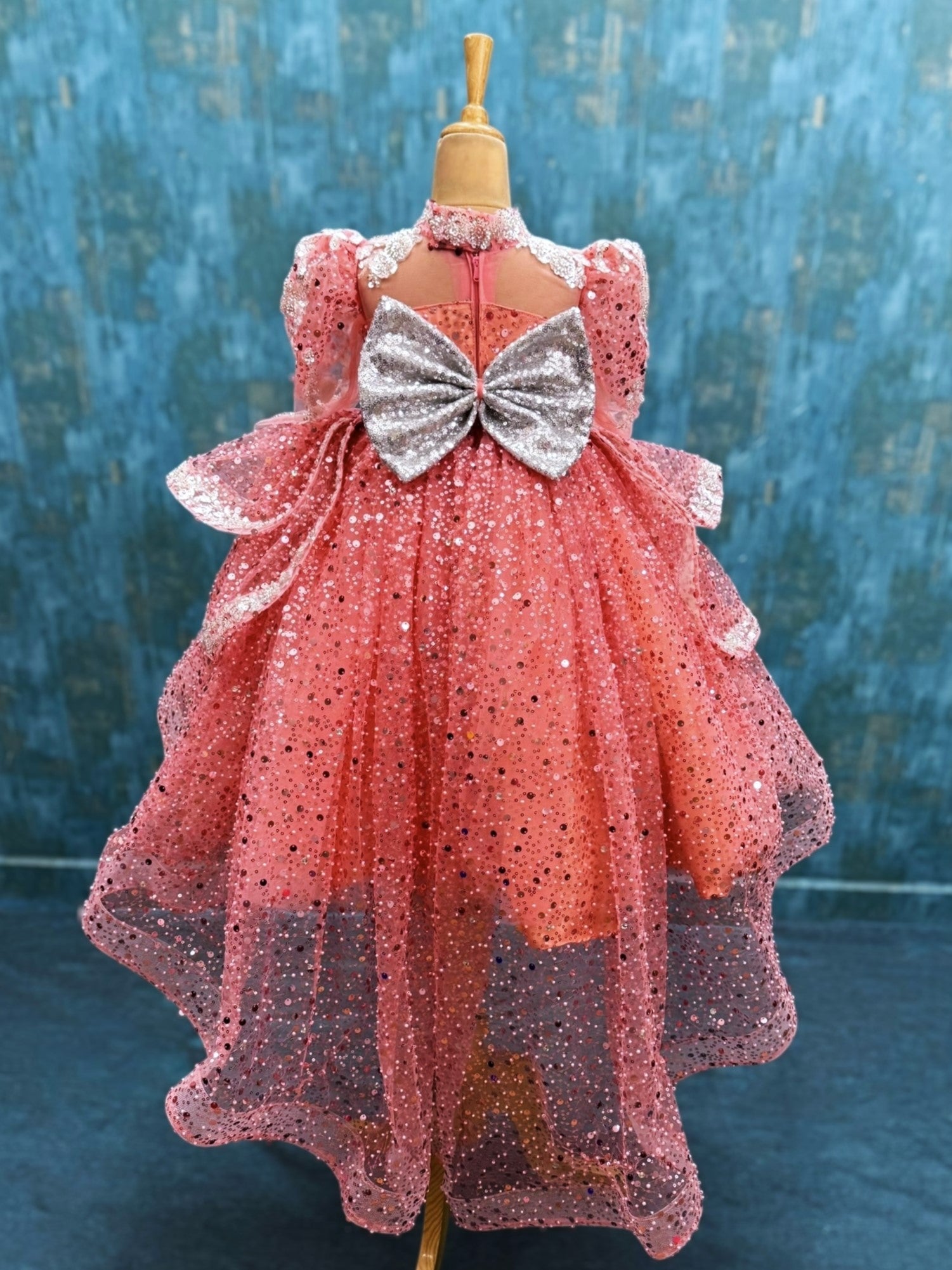 peach sequence ball gown with high neck and puff sleeves with silver intricate work